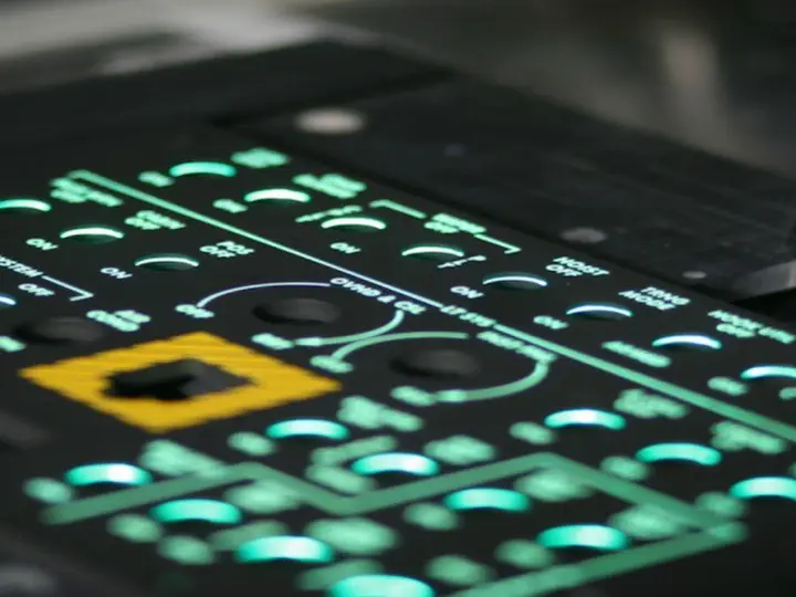 Avionics panel with green illuminated legends and switch positions