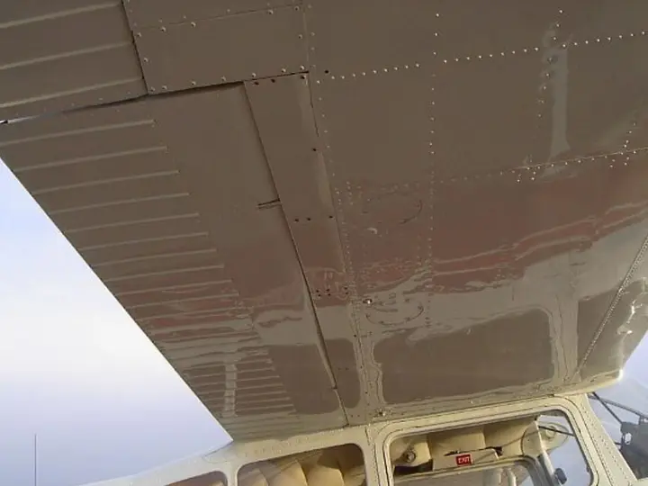 Underside of an aircraft wing with exterior placards