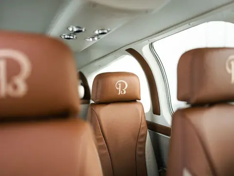 Cabin with custom tan leather seats and embroidered headrests