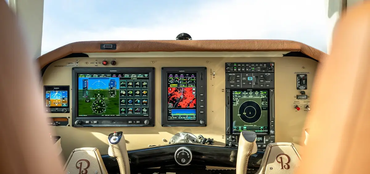 Upgraded instrument panel with three glass displays seen from the pilot seat