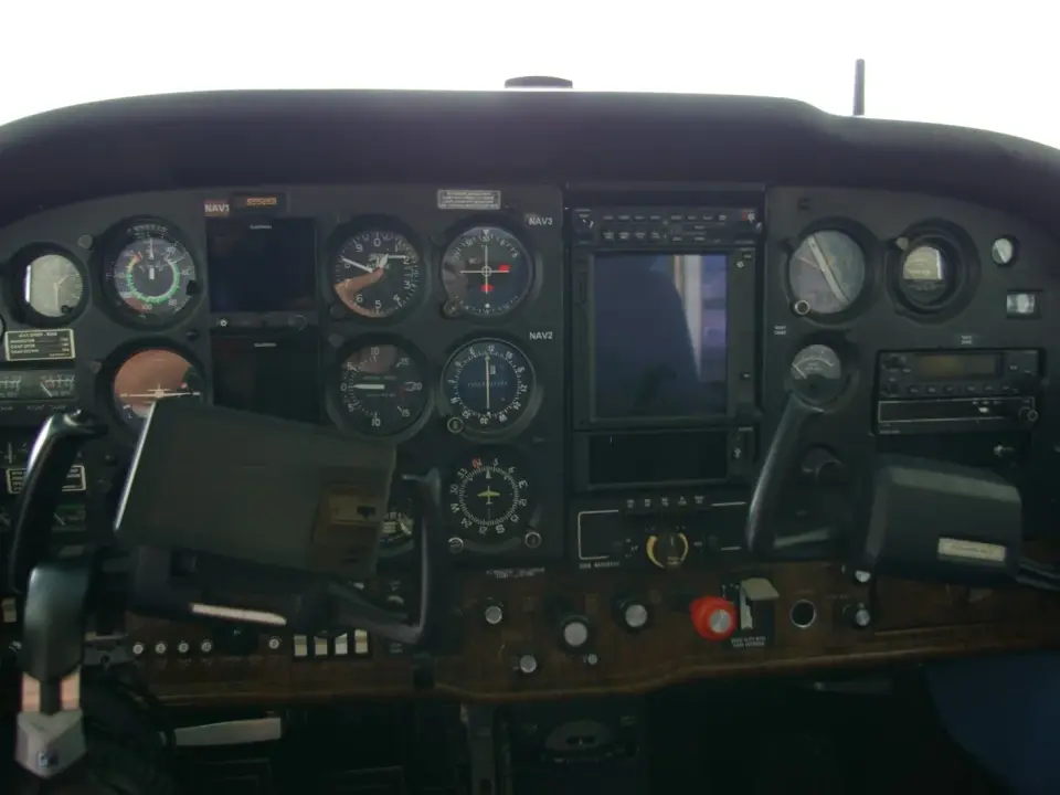 Original panel with steam gauges and a tablet on the yoke