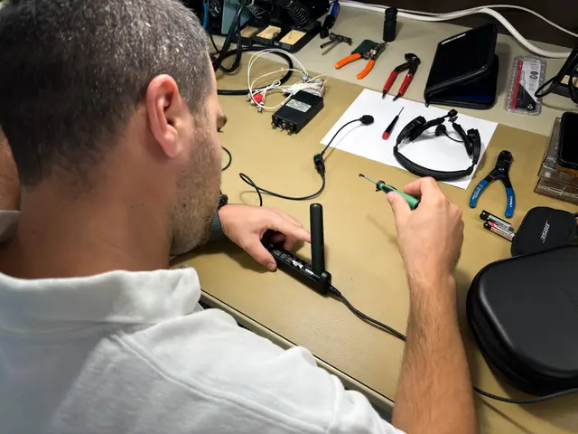Technician soldering a headset connector