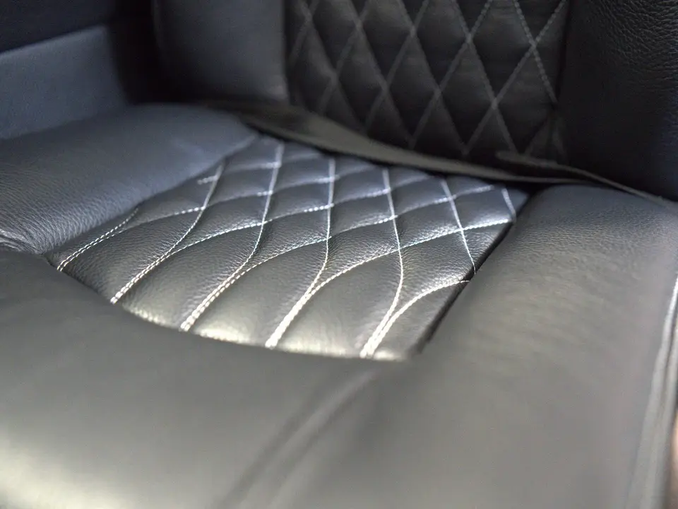 Diamond-stitched black leather seat cushion after refurbishment