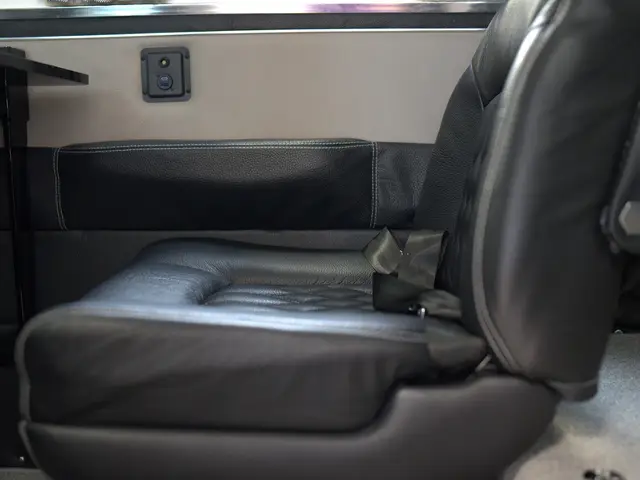 Black leather cabin seat beside a matching door panel in a Cessna 340