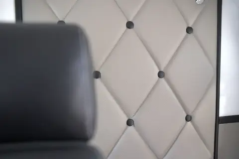 Quilted leather sidewall panel in a business cabin