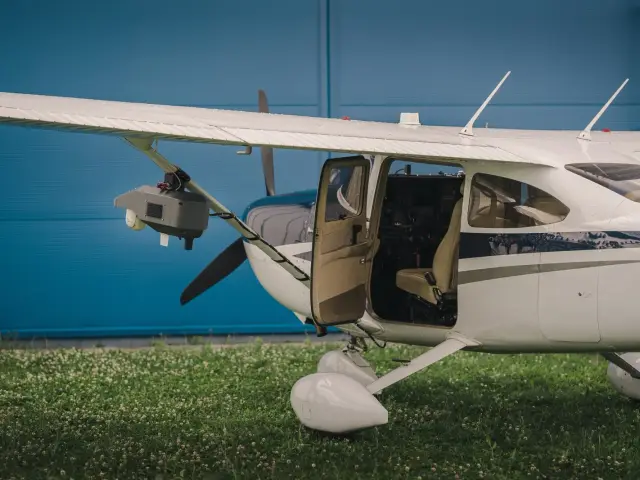 Skylane with the cabin door open on the grass