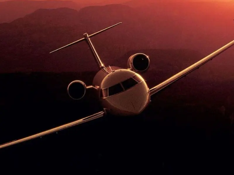 Business jet in flight at dusk