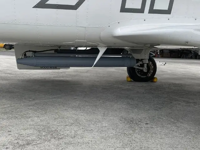 Close-up of the GOSHAWK radar pod and fairing under the fuselage, APEX livery above