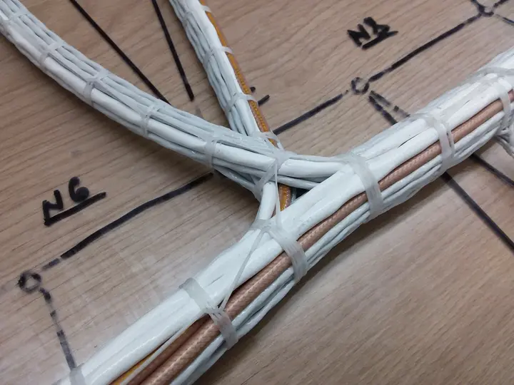 Laced wiring harness on a form board with routing drawn on the board