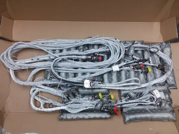 Several finished harness assemblies boxed for shipping