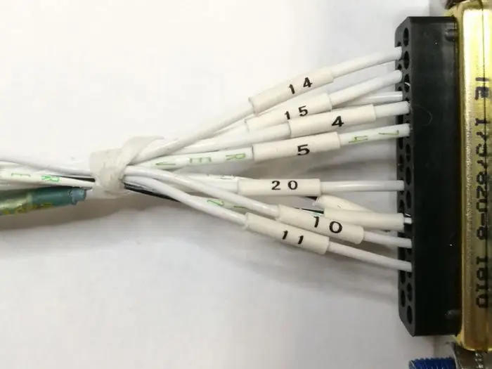 Wires with printed sleeve markings entering a multi-pin connector