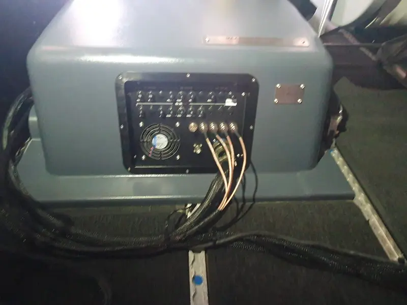 Aircraft cabin with a mission line-replaceable unit mounted and cables routed