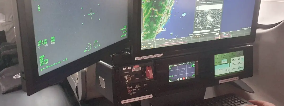 Operator at the mission workstation inside the cabin of a special mission aircraft