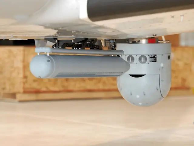 SAR radar pod and EO/IR turret installed under the fuselage in the hangar