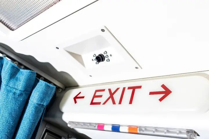 Cabin ceiling with a fitted exit sign and curtain