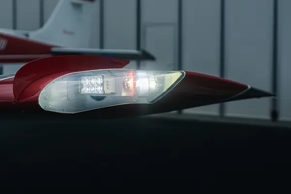Illuminated LED light assembly on a red wingtip