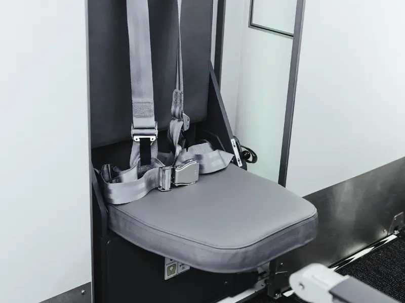 Refurbished grey leather aircraft seat with a seat belt