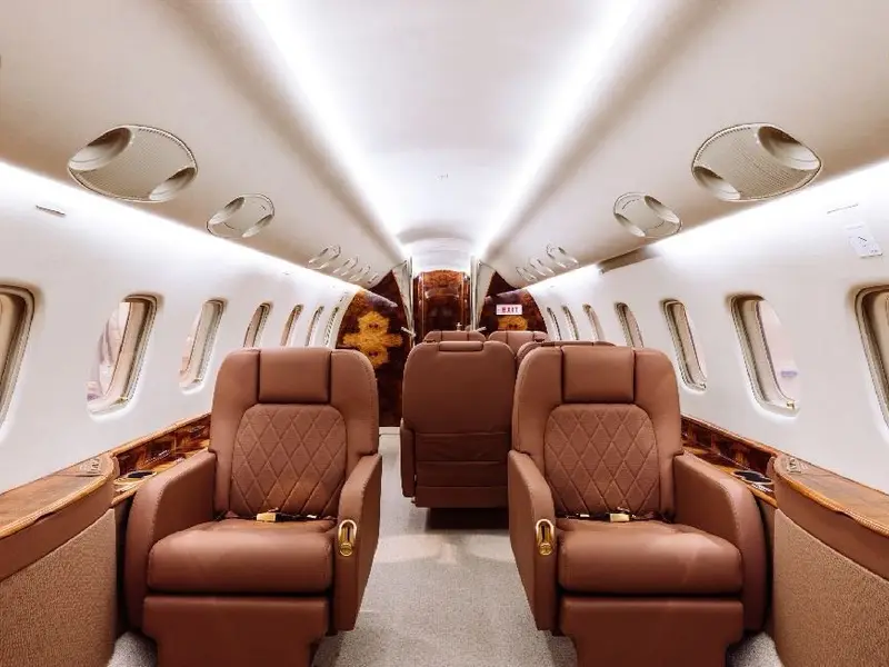 Completed business jet cabin with leather seats and wood trim